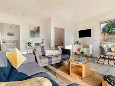 a living room with two couches and a table at 2 Bed in Colchester oc-95941 in East Bergholt