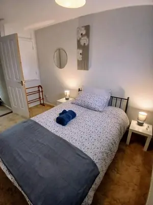 a bedroom with a bed with a blue towel on it at Ipswich Town 3 Bed House in Copdock