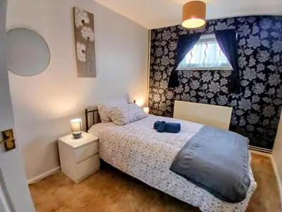 a small bedroom with a bed and a window at Ipswich Town 3 Bed House in Copdock