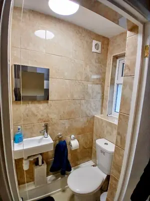 a bathroom with a toilet and a sink at Ipswich Town 3 Bed House in Copdock