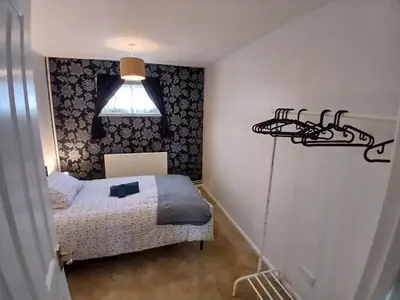 a small bedroom with a bed and a light at Ipswich Town 3 Bed House in Copdock