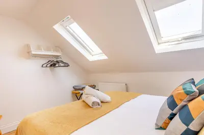 a bedroom with a bed with a skylight at 4 Bed in Harwich oc-s30791 in Harwich
