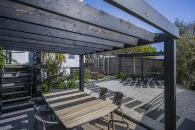 a wooden table and chairs on a patio at 4 Bed in Harwich oc-s30791 in Harwich