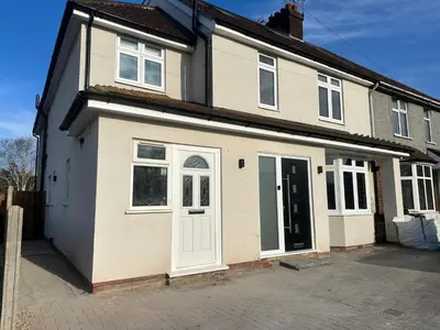 a house with a white door and a driveway at Captivating 7 -Bed House in Waltham Abbey in Waltham Abbey
