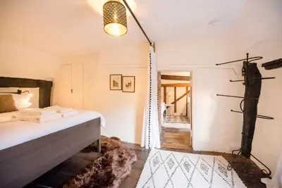 a bedroom with a bed and a shower in a room at Wayside Cottage, Dennington in Brundish