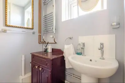a bathroom with a sink and a mirror at Nice and spacious room in Chesterton