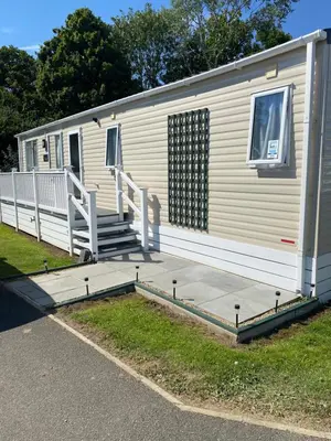 a mobile home with a ramp and a porch at 2 Bed Static Caravan sleeps 6 Saxmunham in Saxmundham