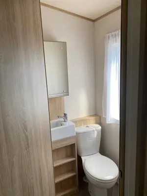a bathroom with a white toilet and a sink at 2 Bed Static Caravan sleeps 6 Saxmunham in Saxmundham