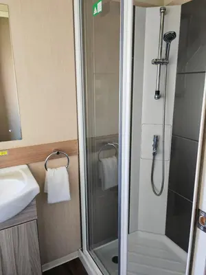 a bathroom with a shower and a sink at Green House Moselle in Jaywick Sands