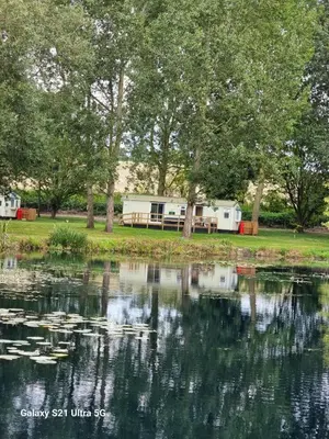 a view of a lake with trees and a campsite at The Fox - Free Fishing, pets welcome - static caravan in Clare, Suffolk in Clare