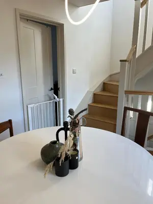 a white table with a vase on top of it at Charming Home in Central Cambridge in Cambridge
