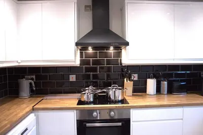 a kitchen with pots and pans on a stove at Luxury 3 bedroom house in Harlow, Essex in Harlow