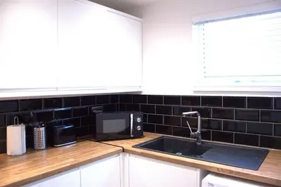 a kitchen with a sink and a microwave at Luxury 3 bedroom house in Harlow, Essex in Harlow