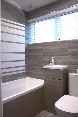 a bathroom with a tub and a toilet and a sink at Luxury 3 bedroom house in Harlow, Essex in Harlow