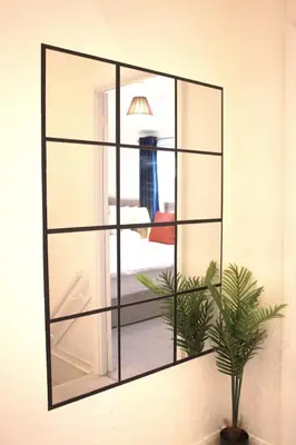 a mirror on a wall with a plant at Luxury 3 bedroom house in Harlow, Essex in Harlow