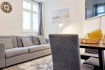 a living room with a couch and a table at Spacious 4 Bedroom Home - Sleeps Up to 9 Guests in Chelmsford