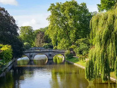 a bridge over a river in a park at R&O Property Experts 2 BR Super Central Cambridge in Cambridge