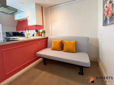 a bench with two yellow pillows on it in a kitchen at R&O Property Experts 2 BR Super Central Cambridge in Cambridge