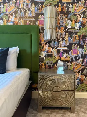 a bedroom with a bed and a wall with disney mural at Elveden Inn in Elveden