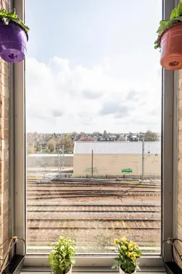a window with a view of a train track at Comfy city room in Cambridge