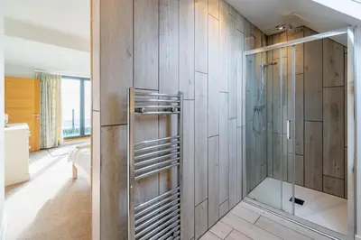 a bathroom with a shower with a glass door at Chicoutimi in Thorpeness