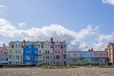 a row of colorful houses on the beach at Chicoutimi in Thorpeness