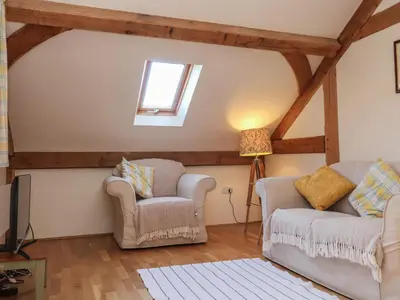 a living room with two chairs and a window at Woodland Retreat Lodge in Woodbridge