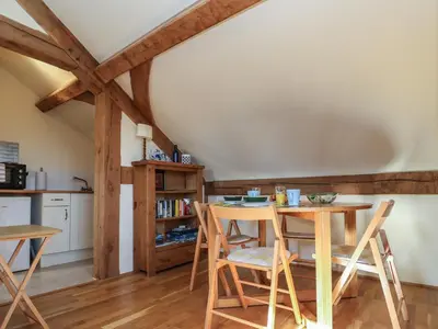 a kitchen and dining room with a table and chairs at Woodland Retreat Lodge in Woodbridge