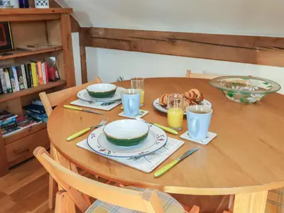a wooden table with plates of food on it at Woodland Retreat Lodge in Woodbridge