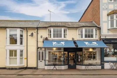a building with a blue awning on a street at The Nest, Aldeburgh - Prime location close to the beach and town amenities - Aldeburgh Coastal Cottages in Aldeburgh