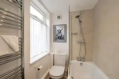 a bathroom with a toilet and a tub and a sink at The Nest, Aldeburgh - Prime location close to the beach and town amenities - Aldeburgh Coastal Cottages in Aldeburgh