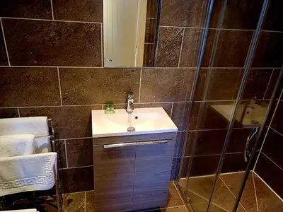 a bathroom with a sink and a shower at the walnut tree in Worlington