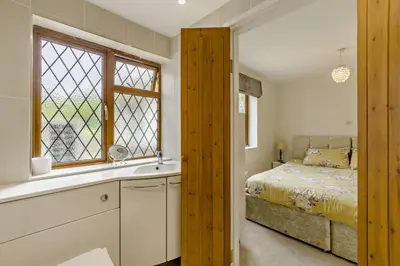 a bedroom with a bed and a window at Finest Retreats - The House at No 47 in West Wickham