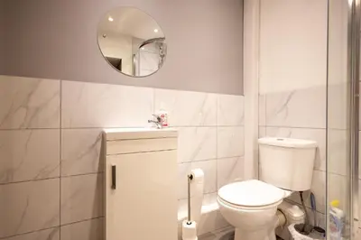 a bathroom with a toilet and a mirror at High Street 200A in Wickham Market