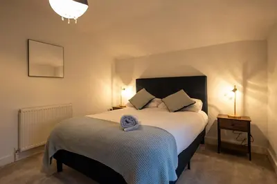 a bedroom with a bed with a blue towel on it at High Street 200A in Wickham Market