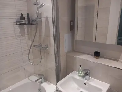 a bathroom with a shower and a sink at Richfield Lux in Loughton