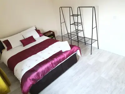 a bedroom with a bed with purple sheets and a ladder at Modern Cambridge Flat-Easy A14 Access and City Links in Milton