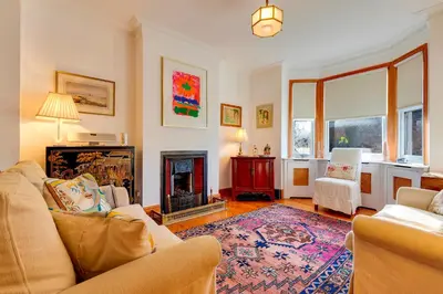 a living room with a couch and a fireplace at Pass the Keys Charming Cottage in the City Centre Free Parking in Cambridge