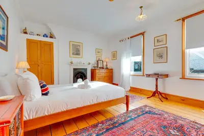 a bedroom with a large bed and a fireplace at Pass the Keys Charming Cottage in the City Centre Free Parking in Cambridge
