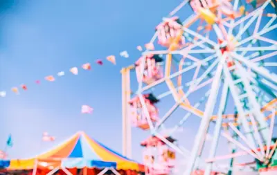 a carnival with a ferris wheel and tents at Lovely 6 Berth Caravan With Decking At Suffolk Sands Holiday Park Ref 45005Hc in Felixstowe