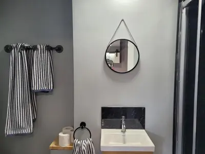 a bathroom with a sink and a mirror on the wall at The Nook in Great Cornard