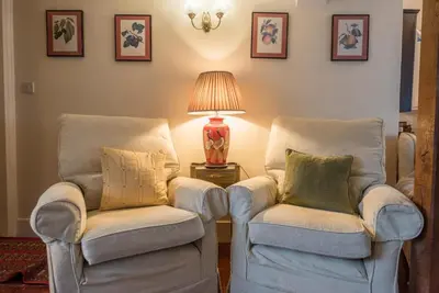 a living room with two chairs and a lamp at Varley House, Saxmundham in Saxmundham