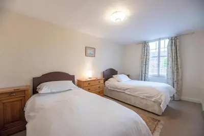 a bedroom with two beds and a window at Varley House, Saxmundham in Saxmundham