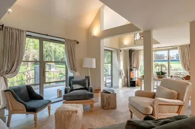 a living room with furniture and a large window at 5 Bed in Cowlinge oc-t27606 in Cowlinge