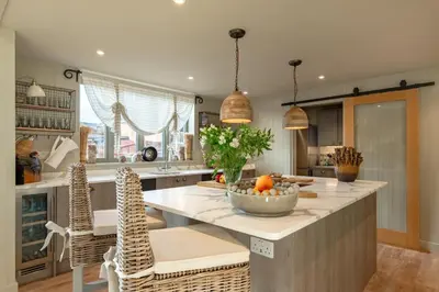 a kitchen with a island with a bowl of fruit on it at 5 Bed in Cowlinge oc-t27606 in Cowlinge
