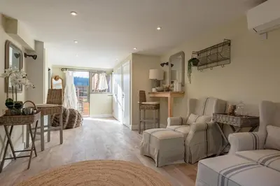 a living room with a couch and chairs and a table at 5 Bed in Cowlinge oc-t27606 in Cowlinge