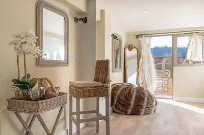 a room with two mirrors and a chair and a stool at 5 Bed in Cowlinge oc-t27606 in Cowlinge