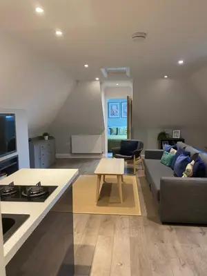 a living room with a couch and a table at Primrose Lodge in Maldon in Maldon