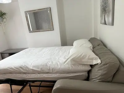 a bed with two pillows on it in a room at Place to stay up Ipswich near the train station, football stadium, waterfront in Ipswich