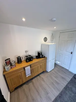 a kitchen with a white refrigerator and a wooden counter at Sunnyside guest house in Latchingdon and Snoreham